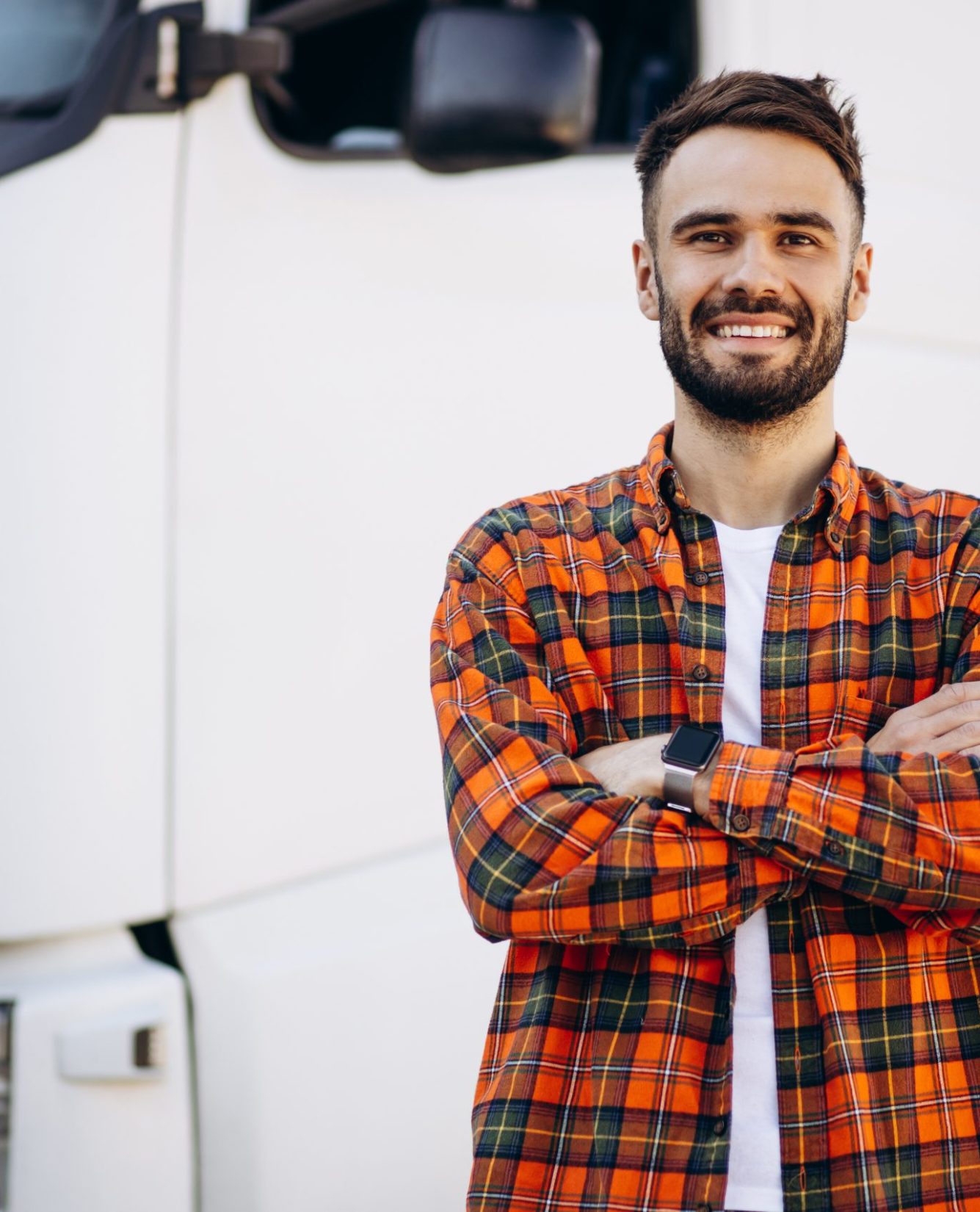 Man trucker smiling and standing by the lorry